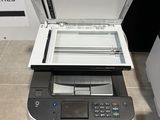 a printer sitting on top of a printer on the floor