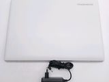 a white laptop with a charger attached to it