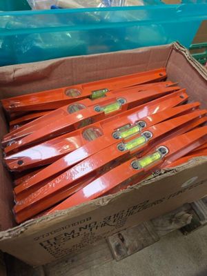 a box full of orange skis sitting on the floor