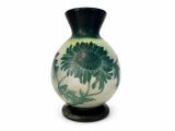 a vase that has a green and white design on it