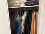a closet full of clothes and other items in it
