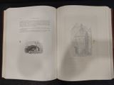 an open book with a drawing of a castle on it