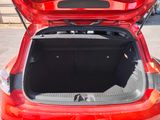 a red car with its trunk open in a parking lot