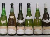 several bottles of wine are lined up on a table