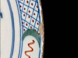 a blue and white plate with a design on it