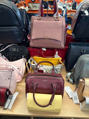 a lot of purses on a table in a store