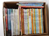 a box full of children ' s books sitting on a table