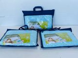 three bags of blue plastic bags sitting on top of a white table