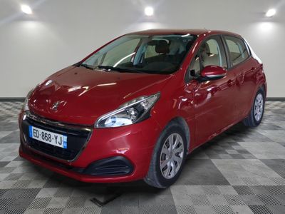 la voiture rouge est garée sur un sol en damier dans le garage