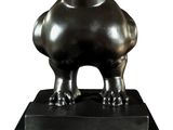 statue of a black bird on a black base on a white background