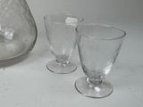 two glasses and a pitcher on the table