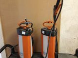 two orange and white fire extinguisors sitting on the floor