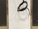 a metal box with a black cord attached to it