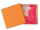 an orange box with a pink scarf inside of it