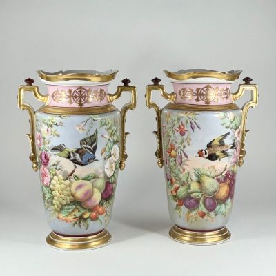 pair of vases decorated with birds and flowers on a white background