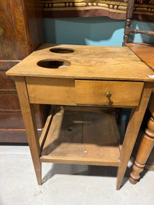 a small wooden table with a drawer underneath it