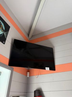 a flat screen tv hanging on the wall in a room
