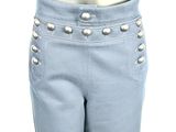 the back of a mannequin pants with silver buttons on it