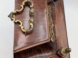 a small wooden box with a handle on it