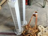 two air purifiers sitting on the floor next to each other