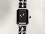 an image of a close up of a wrist watch with a chain around it
