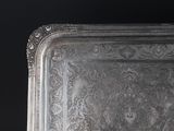 a silver tray on a table with a black background