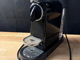 a black coffee machine sitting on top of a wooden table