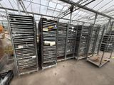 many trays of food inside of a large greenhouse