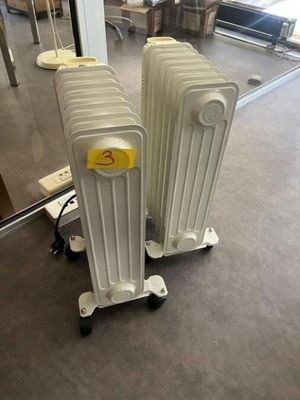 two white radiators that are sitting on the floor