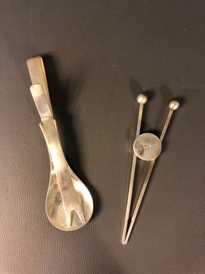 two spoons and a spoon rest on a table