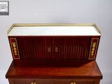 a wooden dresser with a mirror on top of it