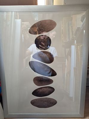 a picture of a man taking a picture of a stack of rocks
