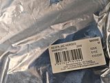 a label on the back of a bag of blue fabric