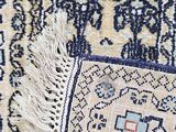 an image of a close up of a rug with fringes on it