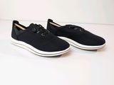 men ' s black slip on sneakers with white soles on a white surface