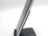 a cell phone on a stand on a white surface