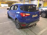 a blue car parked in a parking lot next to other cars