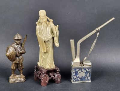 a statue of a man holding a sword next to other statues