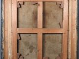 an old wooden window with a wooden frame on the outside of it