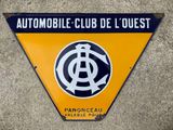 an orange and black sign on the side of a building that says automobile club de l ' quest
