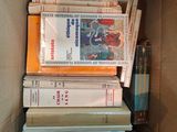 many books in a cardboard box on the floor
