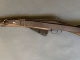 a close up of a rifle on a table with a white background