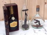 three bottles with a picture of a man and a woman inside of them