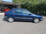 a blue car that is parked in a parking lot
