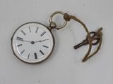 a small pocket watch with a rope hanging from it ' s side