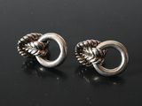 pair of silver tone earrings with a knot on each end