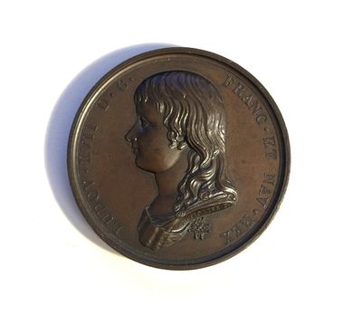 an image of a bronze coin with a woman ' s profile on it