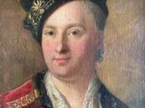 portrait of a young man in a red coat and black hat
