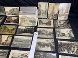 several old black and white photographs of people and buildings on a table