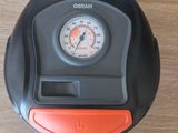 une horloge noire et orange posée sur une table